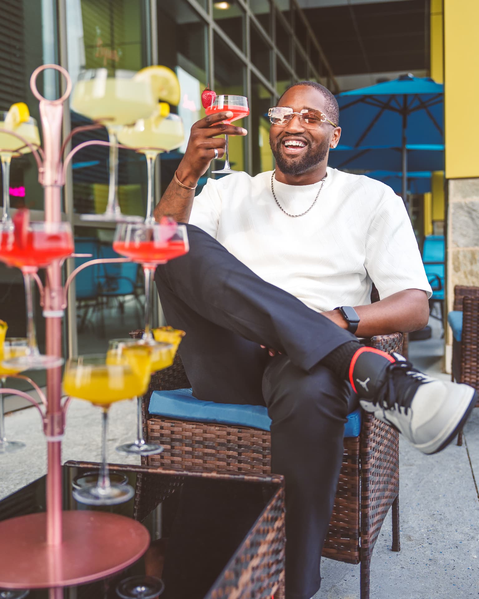 Founder celebrating at a modern lounge with signature cocktails